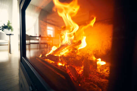 A fire burns in a fireplace, Fire to keep warm. Logs burning in a fireplaceの写真素材
