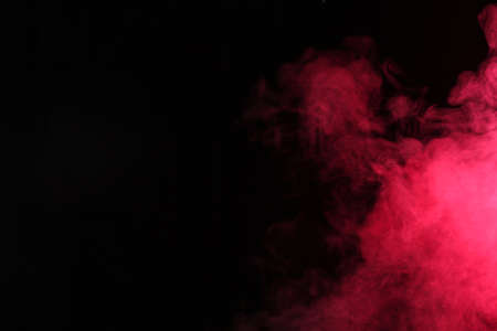 Smoke in red light on black backgroundの写真素材