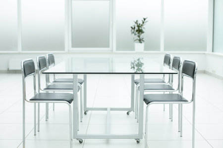 Black chairs glass table in office space