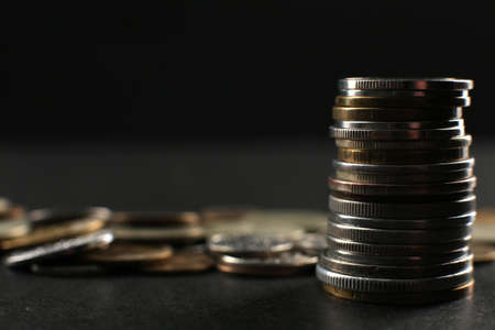 Many coins on a black background. Financial independence conceptの写真素材