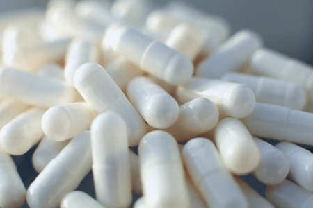 White pills on glass table. Close up
