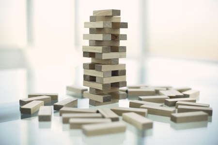 The tower from wooden blocks on glass tableの写真素材