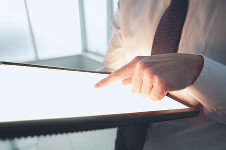 Close-up Of A Businessman Touching Digital Tablet With Forefinger