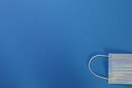 Protective medical mask on blue backgroundの写真素材