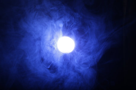 Smoke in blue light on black backgroundの写真素材