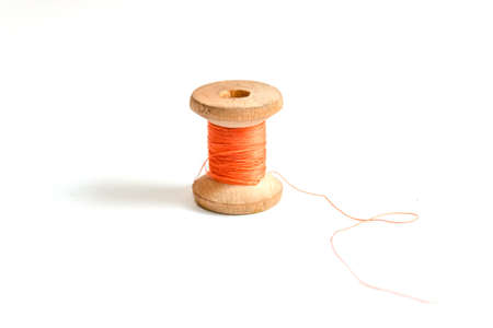 One orange Thread bobbin isolated on white background.の写真素材
