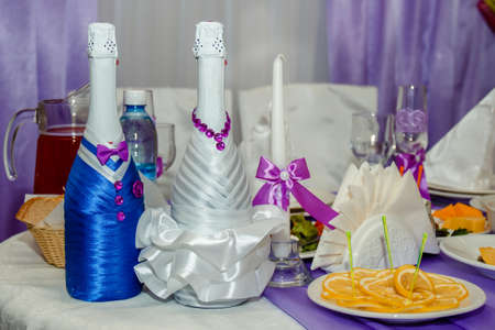 two bottles of champagne in violet decor on a banquette table.の写真素材