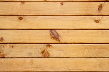 Wood texture background. wooden panel with horizontal gaps, planks and chinks. Background with wooden beams, timber. pine board. Wooden beams. Sawn timber from coniferous wood.の写真素材