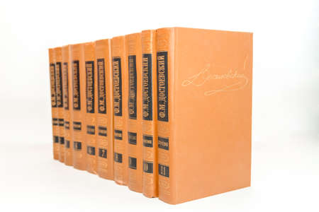 Old books are arranged in a row on white background. perspective view, background, closeup.の写真素材