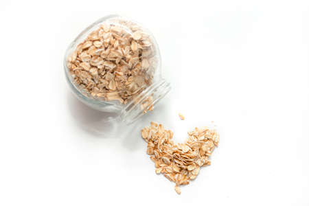 Oatmeal in a jar of glass on a white background, healthy eating and diet concept. Top view.の写真素材