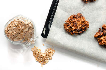 Homemade oatmeal cookies and oat flakes. Proper nutrition conceptの写真素材