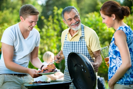 Family having a barbecue party in their garden in summer