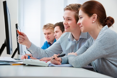 Group of students attending training course in a computer classroomの写真素材