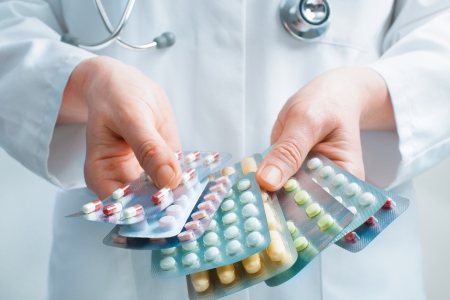 Hand of doctors holding many different pillsの写真素材