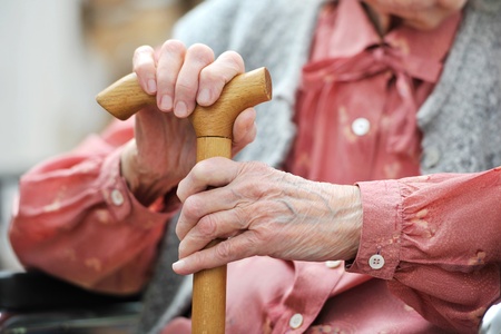 Hands of the old woman with a caneの写真素材