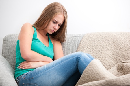 Woman having abdominal pain, upset stomach or menstrual crampsの写真素材