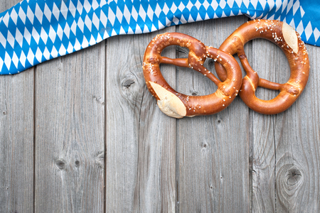 Appetizing pretzels with a bavarian flag  on wooden backgroundの写真素材