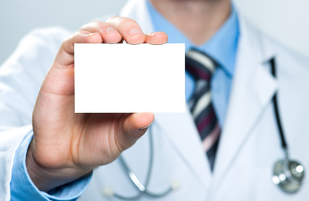Doctor showing his business cardの写真素材