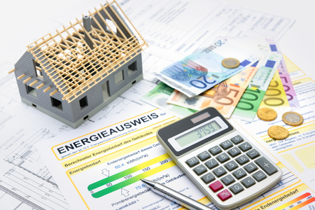 House with money, calculator and an energy efficiency certificateの写真素材
