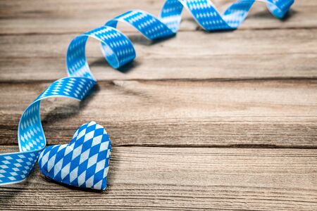 Bavarian ribbon and a heart on wooden background with copy spaceの写真素材