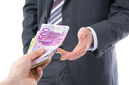 Concept - corruption. Businessman in a suit takes a bribeの写真素材