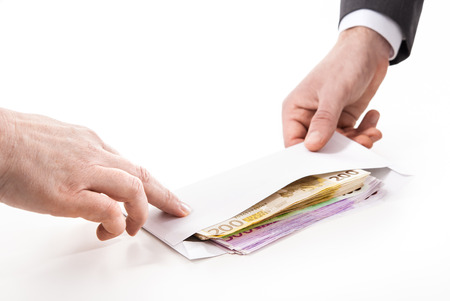 Concept - corruption. Businessman in a suit takes a bribeの写真素材