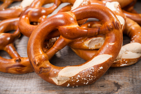 Bavarian pretzels with ribbon on wooden tableの写真素材