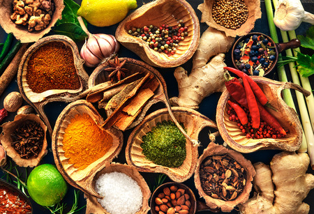 Various herbs and spices on wooden tableの写真素材