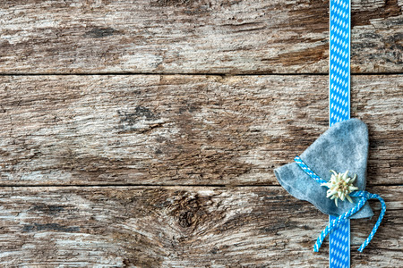 Bavarian hat with edelweiss and ribbon on weathered wood backgroundの写真素材