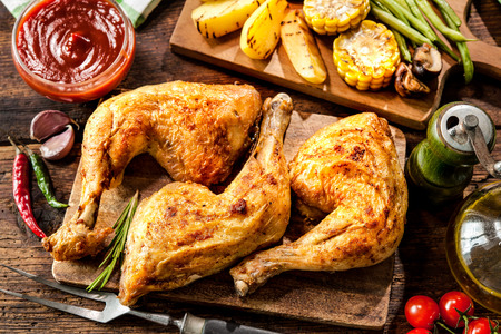 Grilled chicken legs with vegetablesの写真素材