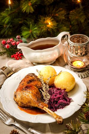 Crusty Christmas goose leg with braised red cabbage and dumplingsの写真素材