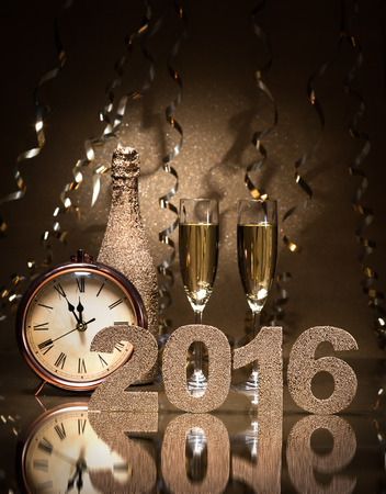 New Years Eve celebration background with pair of flutes, bottle of champagne and a clock