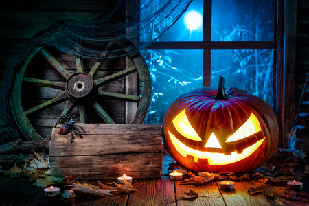 Halloween pumpkin head jack lantern with burning candlesの写真素材