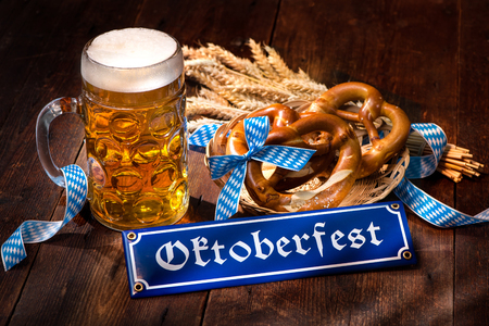 Original bavarian pretzels with beer stein on wooden board. Oktoberfest backgroundの写真素材