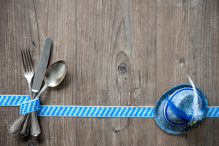 Bavarian cutlery on wooden table with copy space. Oktoberfest beer festival background. Menu for Bavarian specialtiesの写真素材