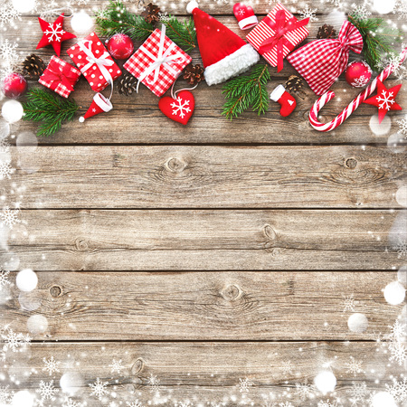 Christmas background with decorations and gift boxes on wooden boardの写真素材