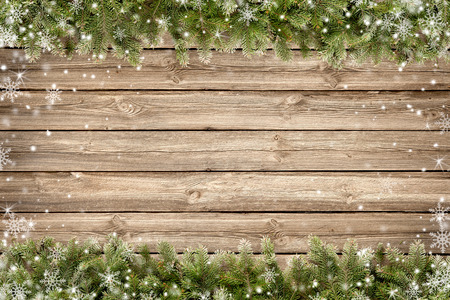 Christmas wooden background with snow fir tree branchesの写真素材