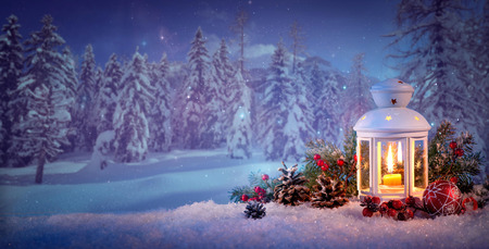 Burning lantern in the snow. Christmas backgroundの写真素材