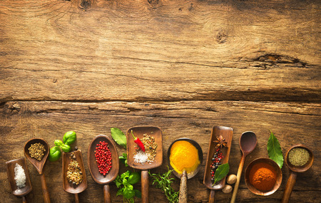 Various herbs and spices on wooden tableの写真素材