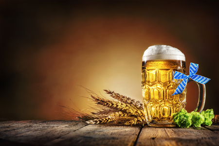 Oktoberfest beer with wheat  and hops on wooden tableの写真素材