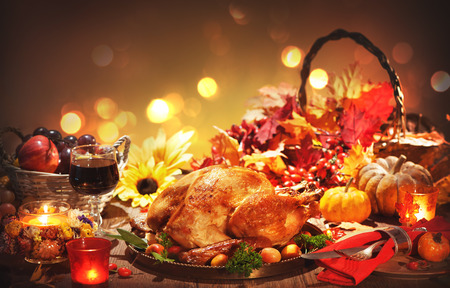 Roasted whole turkey on festive rustic table with autumn decoration for Thanksgiving Dayの写真素材