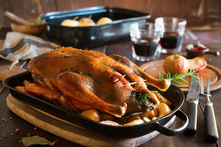 Roast Christmas duck with thyme and applesの写真素材
