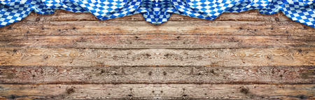 Rustic background for Oktoberfest with bavarian white and blue fabric on woodenの写真素材