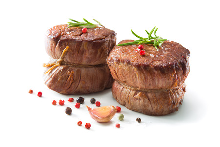 Grilled beef fillet steaks mignon with spices isolated on white backgroundの写真素材