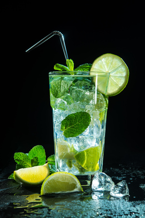 Mojito cocktail with fresh lime and mint on dark backgroundの写真素材