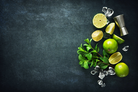Mojito cocktail making. Mint, lime, ice ingredients and bar utensilsの写真素材