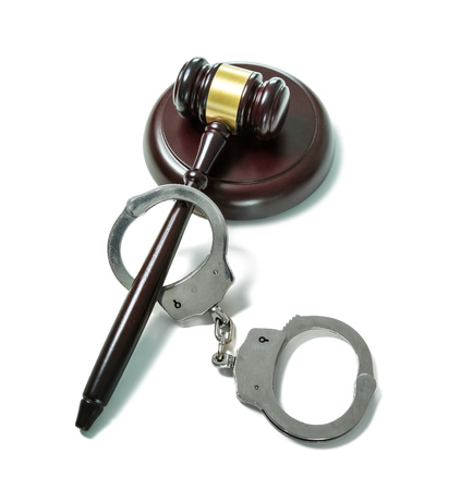 Handcuffs and Judge Gavel isolated on white backgroundの写真素材