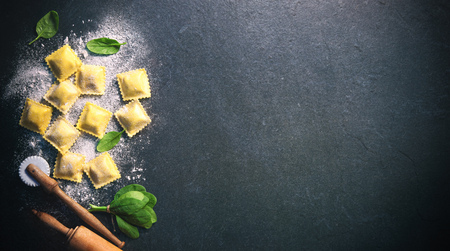 Ravioli with spinach and ricotta on dark background, top viewの写真素材