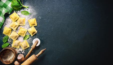 Ravioli with spinach and ricotta on dark background, top viewの写真素材
