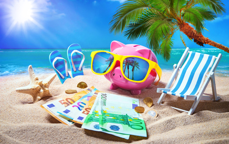Piggy bank with sunglasses relax on the beach holiday. Travel money savings concept, summer vacationの写真素材